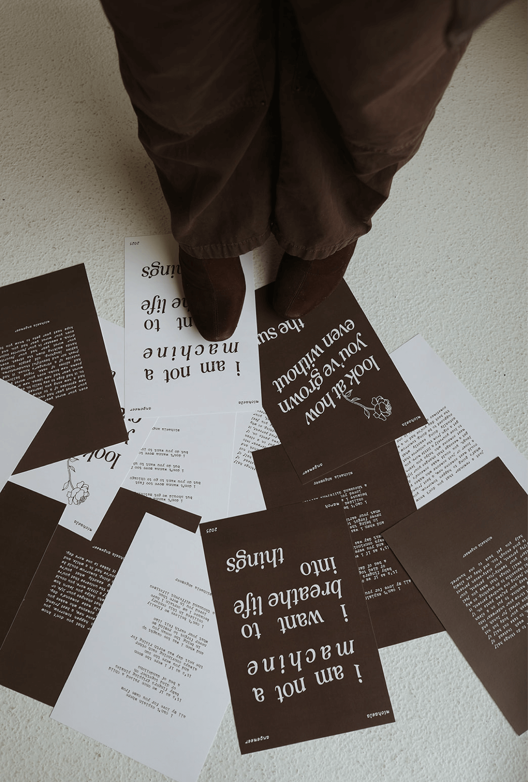 pitter patter poetry art print shop by michaela angemeer photo of brown and white prints on the ground